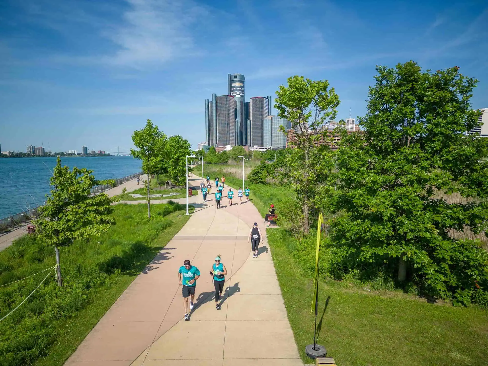 An aerial view of the riverwalk with people walking and running along it